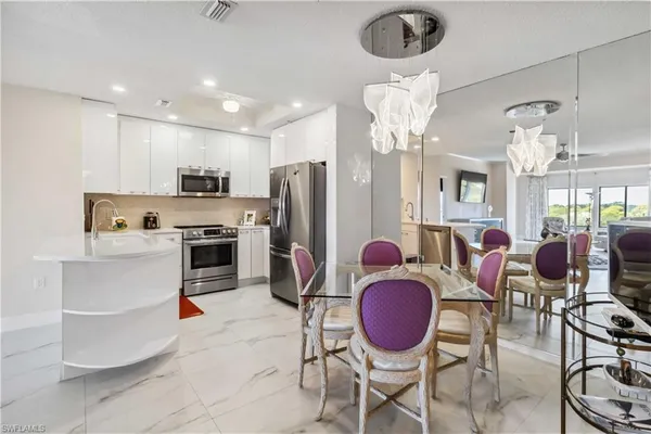 a kitchen with stainless steel appliances a refrigerator stove microwave and sink