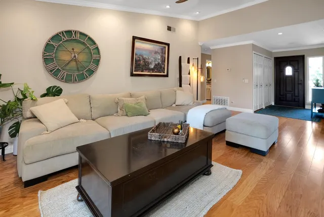 a living room with furniture and a wooden floor