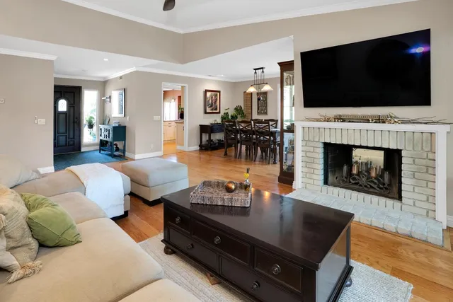a living room with furniture fireplace and flat screen tv