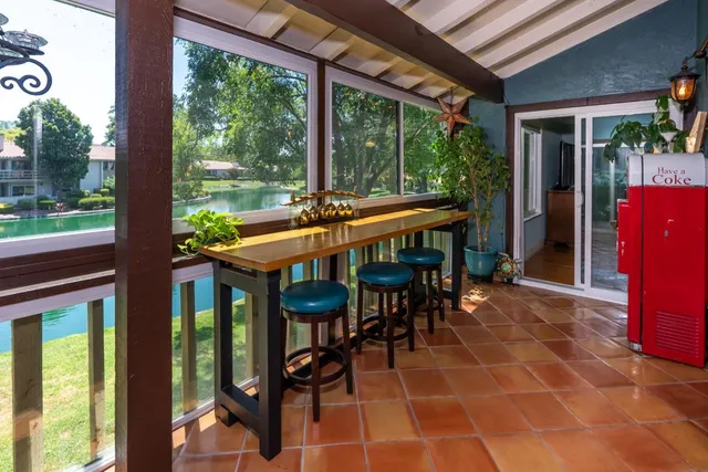 a view of a patio with a table chairs and backyard