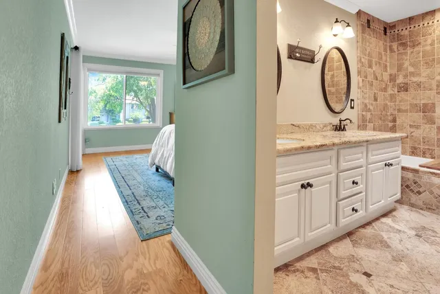a spacious bathroom with a mirror and a sink