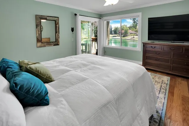 a bedroom with a bed and a flat tv screen