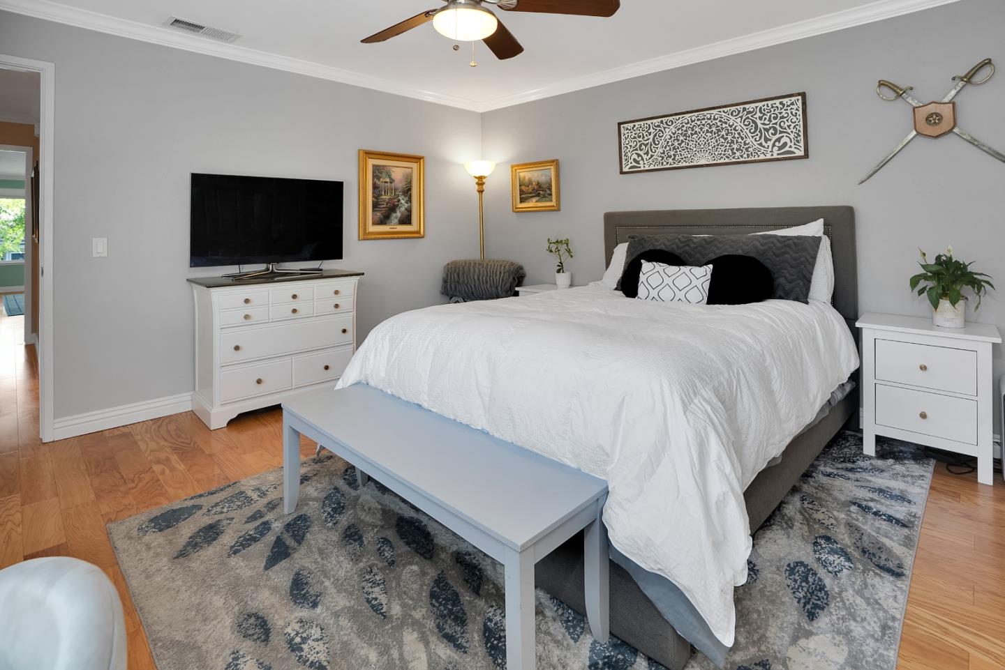 8386 Riesling Way San Jose, CA 95135 - Photo 30 of 45 a spacious bedroom with a bed and a flat screen tv