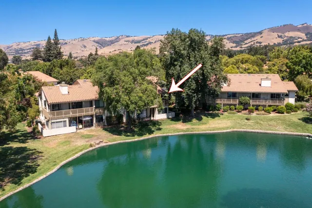 a swimming pool with outdoor seating and yard