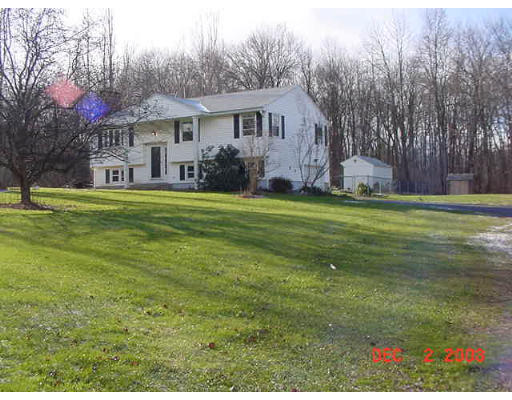 48 Putnam Hill Road Sutton, MA 01590 - Photo 1 of 1 a front view of a house with a garden