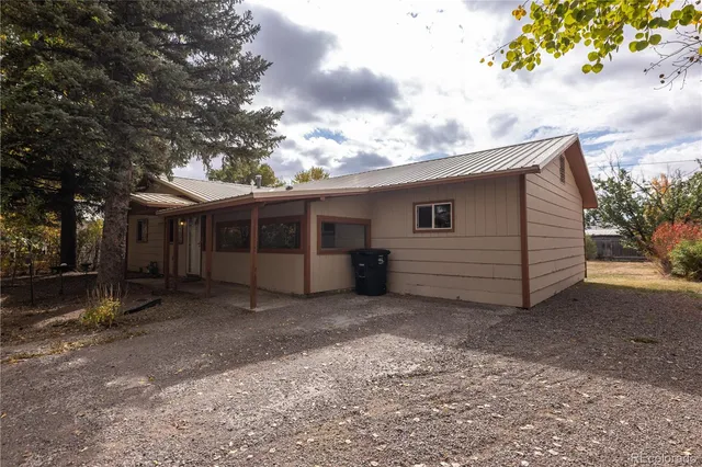 a view of a house with a large tree and a big yard