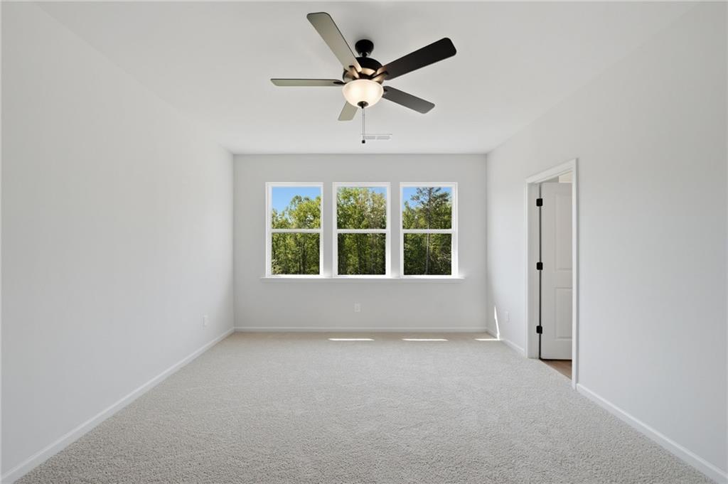 299 Summit View Lane, Unit 5 Jasper, GA 30143 - Photo 21 of 43 an empty room with a ceiling fan and window
