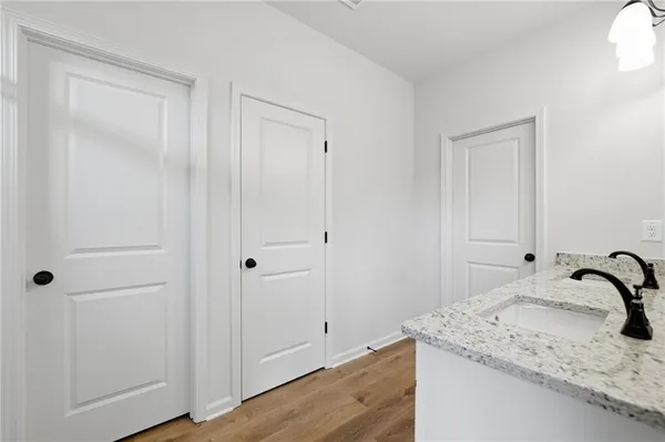 a bathroom with a granite countertop sink and shower