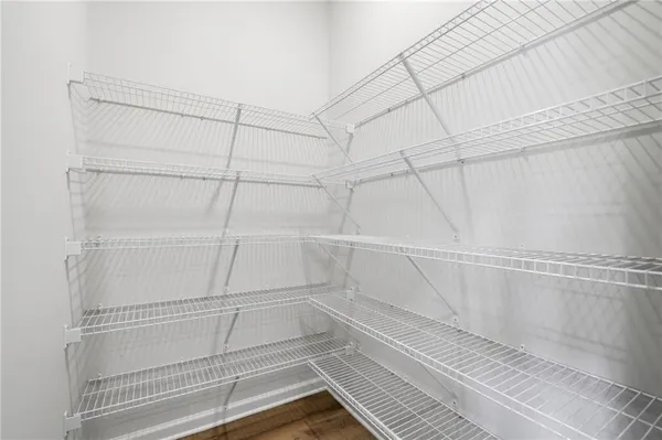 a view of walk in closet with empty racks