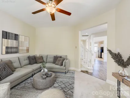 a living room with furniture and a chandelier