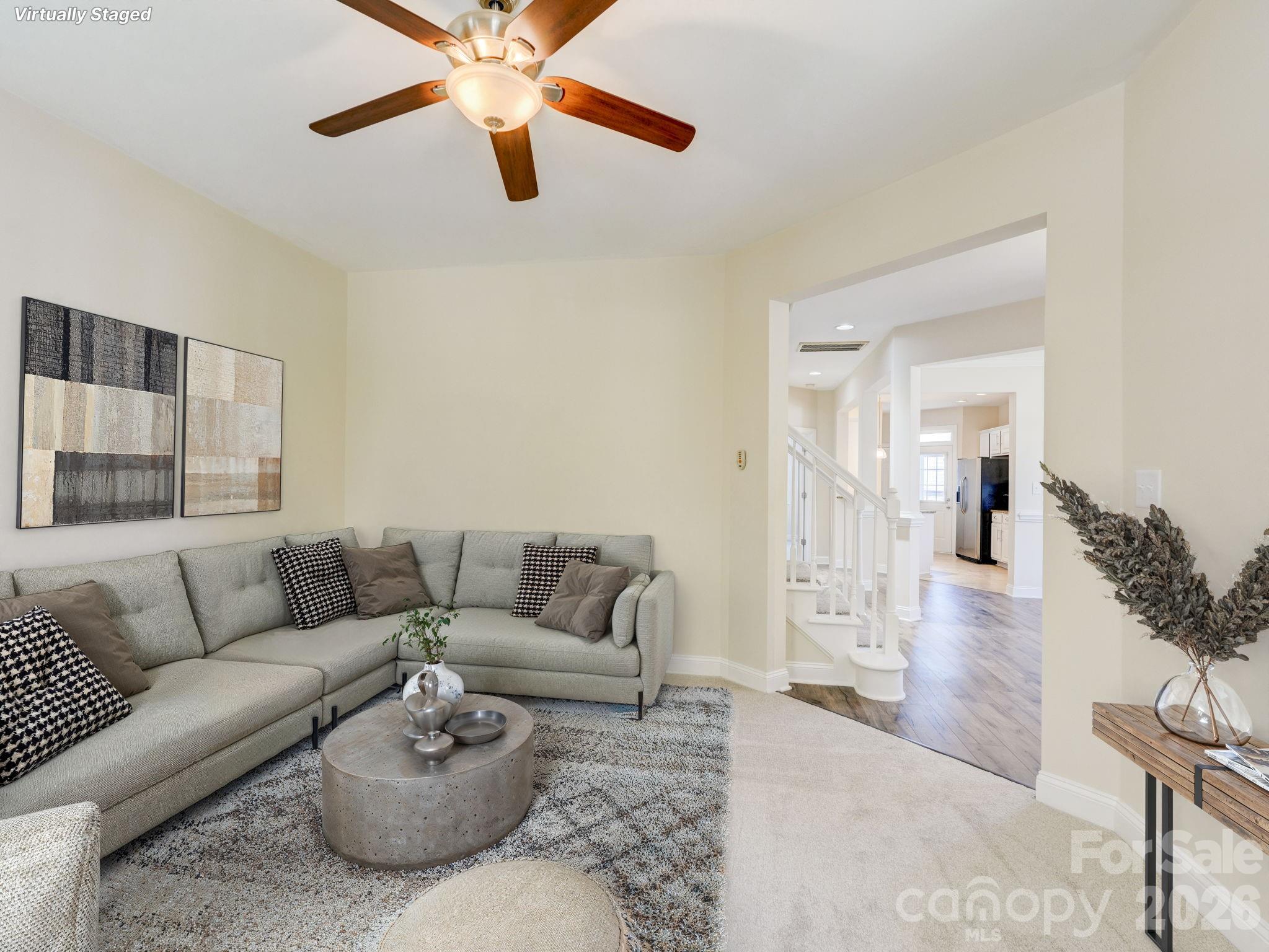 2025 Gable Way Lane Matthews, NC 28104 - Photo 12 of 36 a living room with furniture and a chandelier