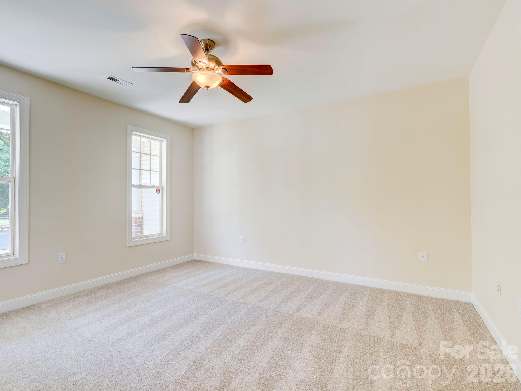 2025 Gable Way Lane Matthews, NC 28104 - Photo 15 of 36 an empty room with windows and fan