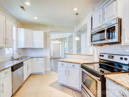 a kitchen with stainless steel appliances granite countertop a stove and cabinets