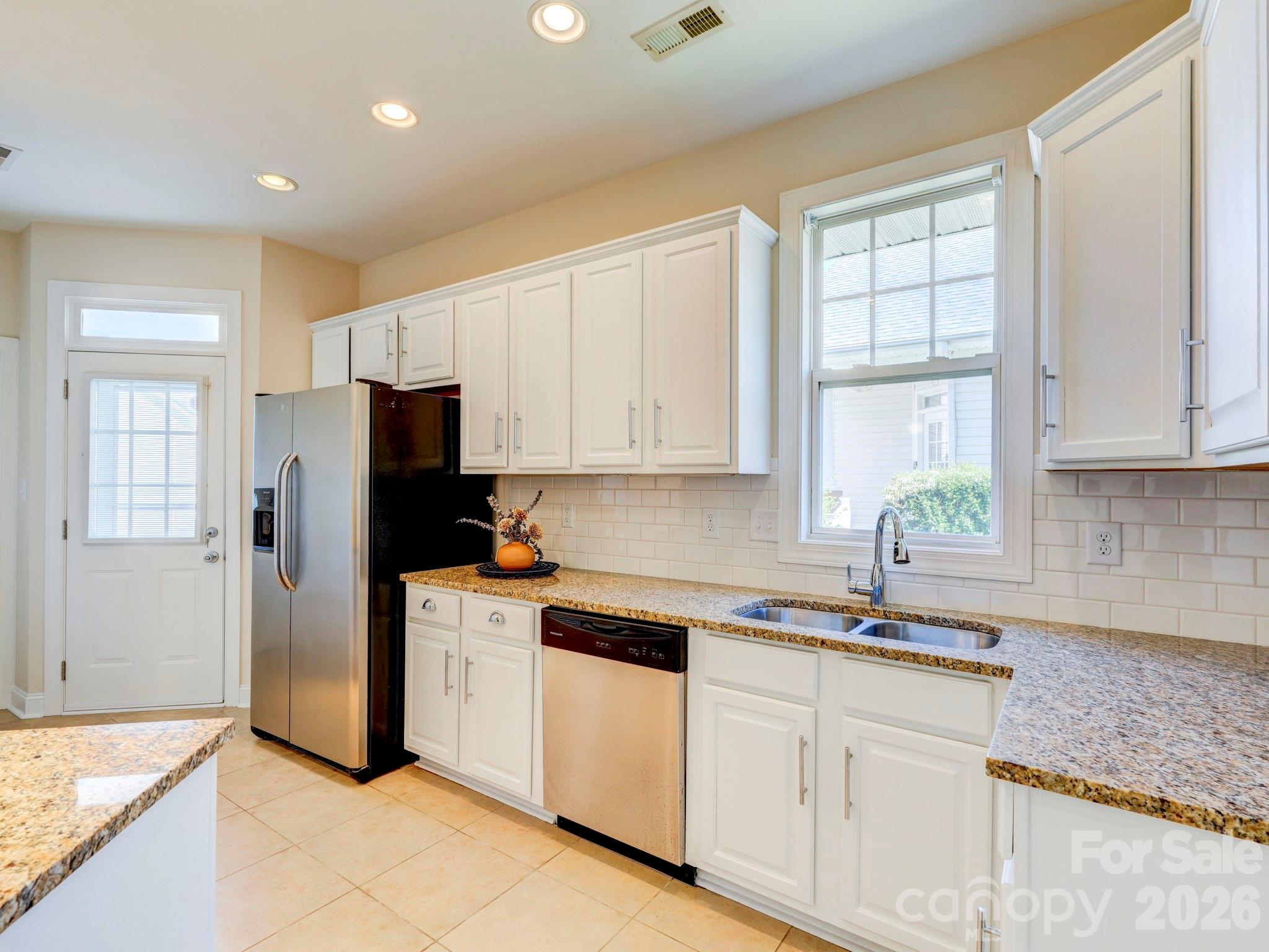 2025 Gable Way Lane Matthews, NC 28104 - Photo 20 of 36 a kitchen with white cabinets and refrigerator