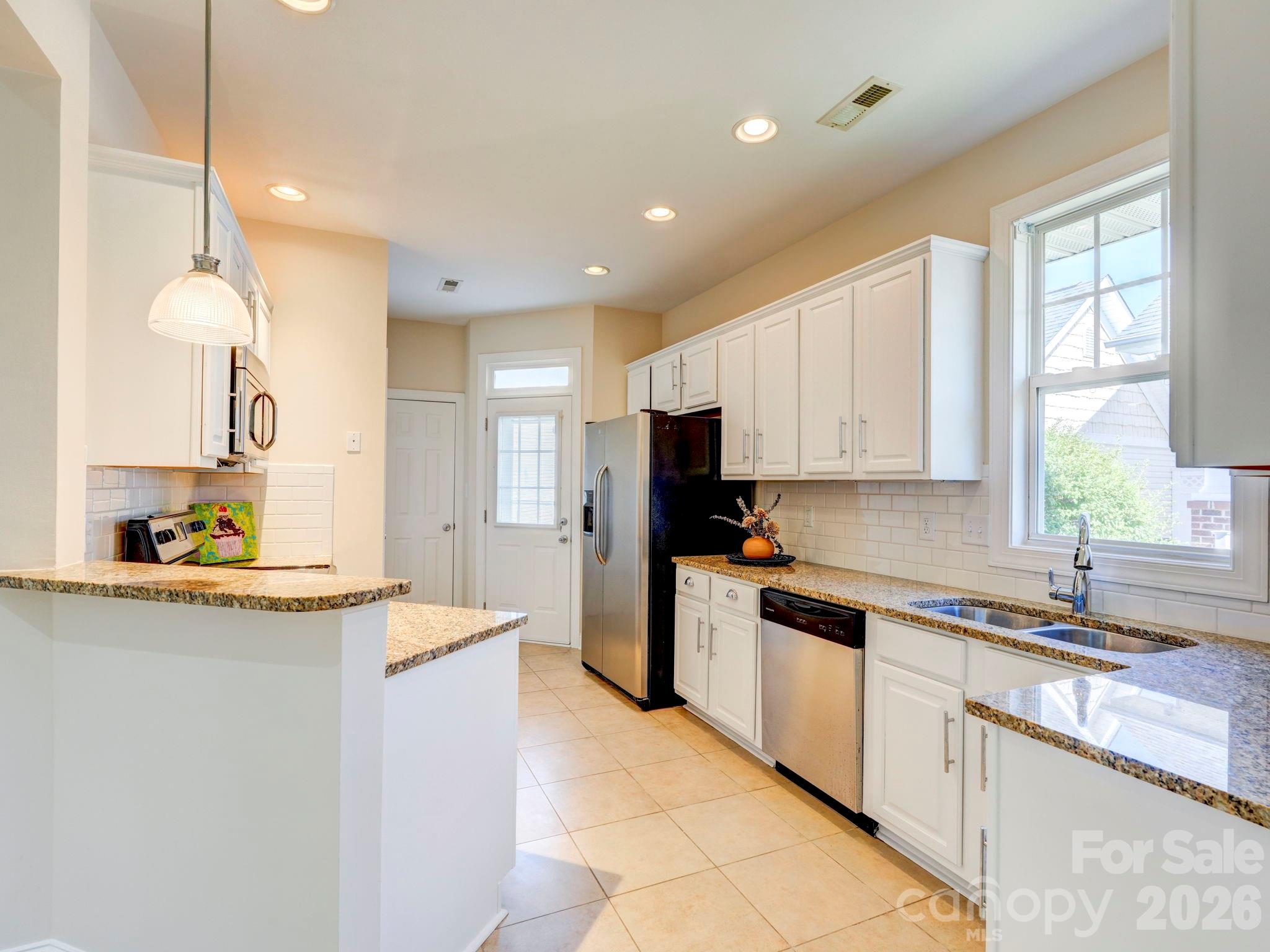 2025 Gable Way Lane Matthews, NC 28104 - Photo 21 of 36 a kitchen with a sink a counter top space stainless steel appliances and cabinets