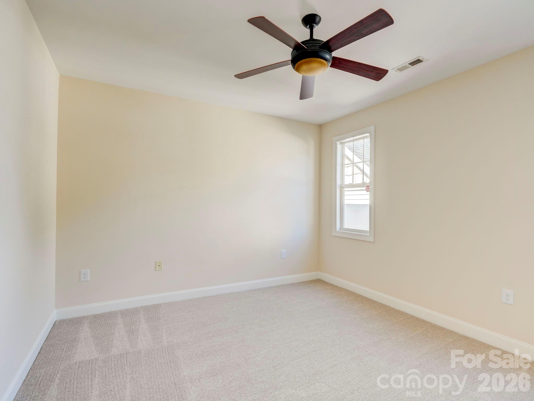 2025 Gable Way Lane Matthews, NC 28104 - Photo 22 of 36 an empty room with a window and a fan
