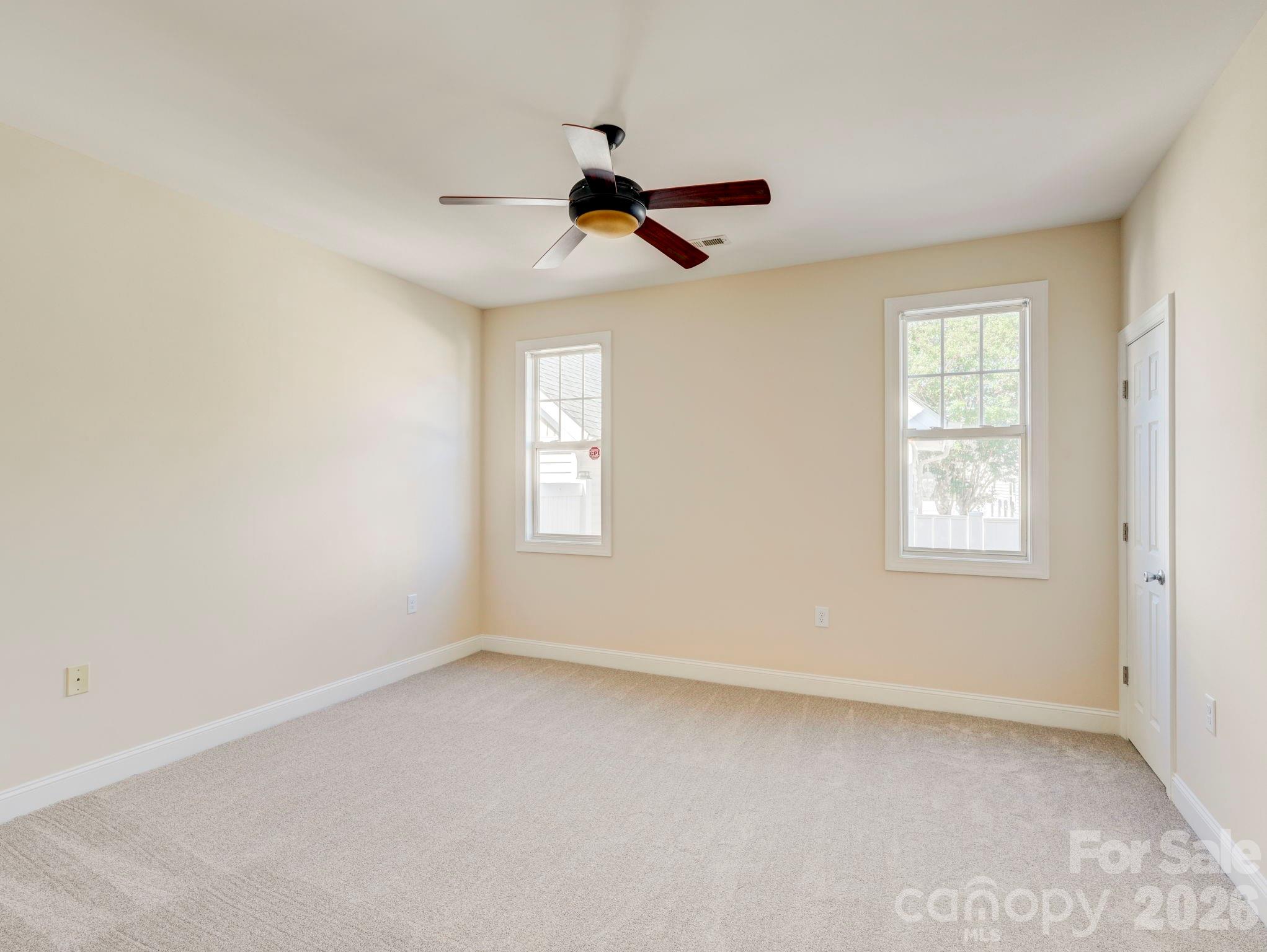 2025 Gable Way Lane Matthews, NC 28104 - Photo 24 of 36 an empty room with windows and fan