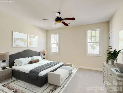 a bedroom with a large bed and wooden floor