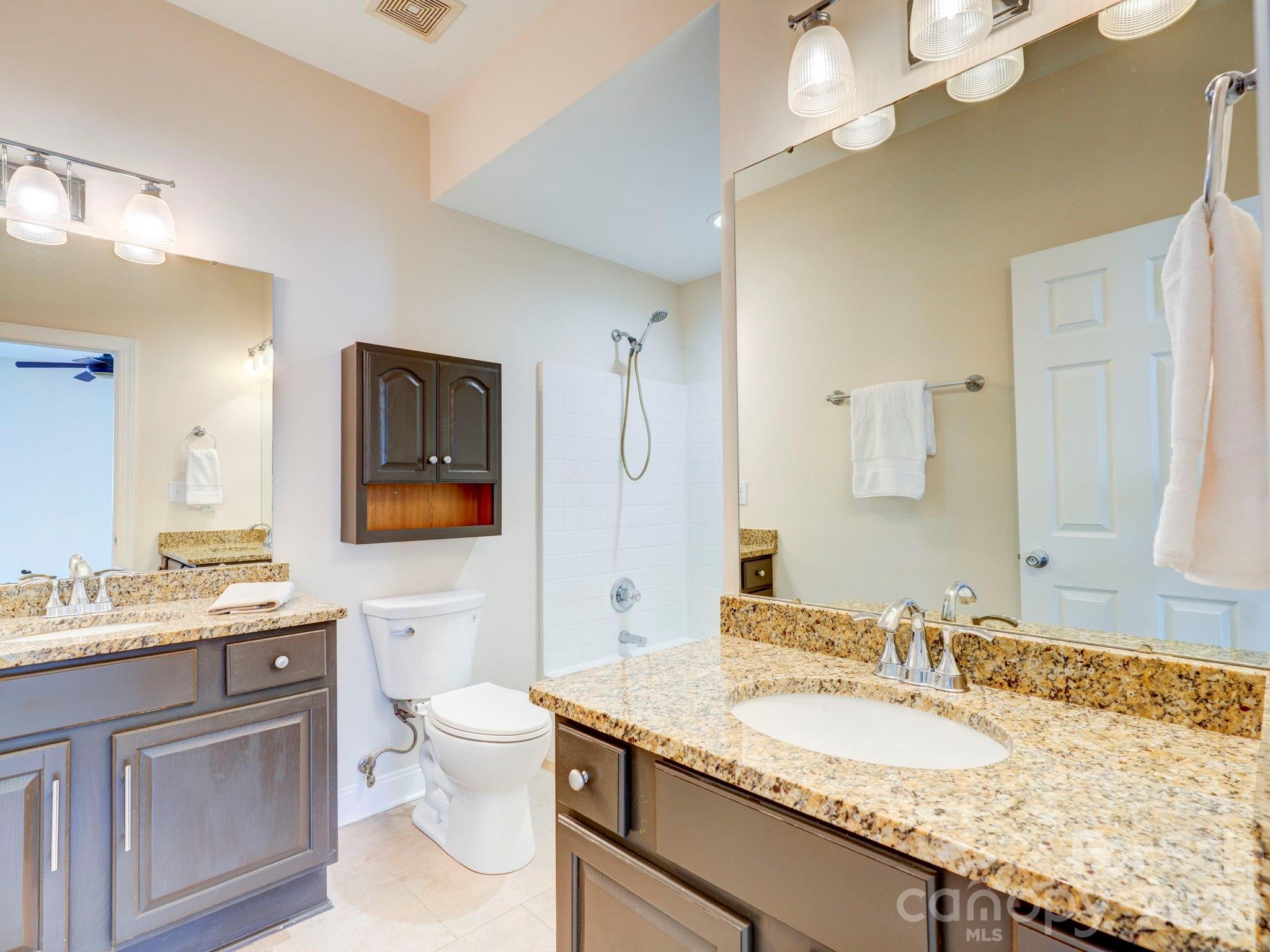 2025 Gable Way Lane Matthews, NC 28104 - Photo 26 of 36 a bathroom with a granite countertop double vanity sink mirror and toilet
