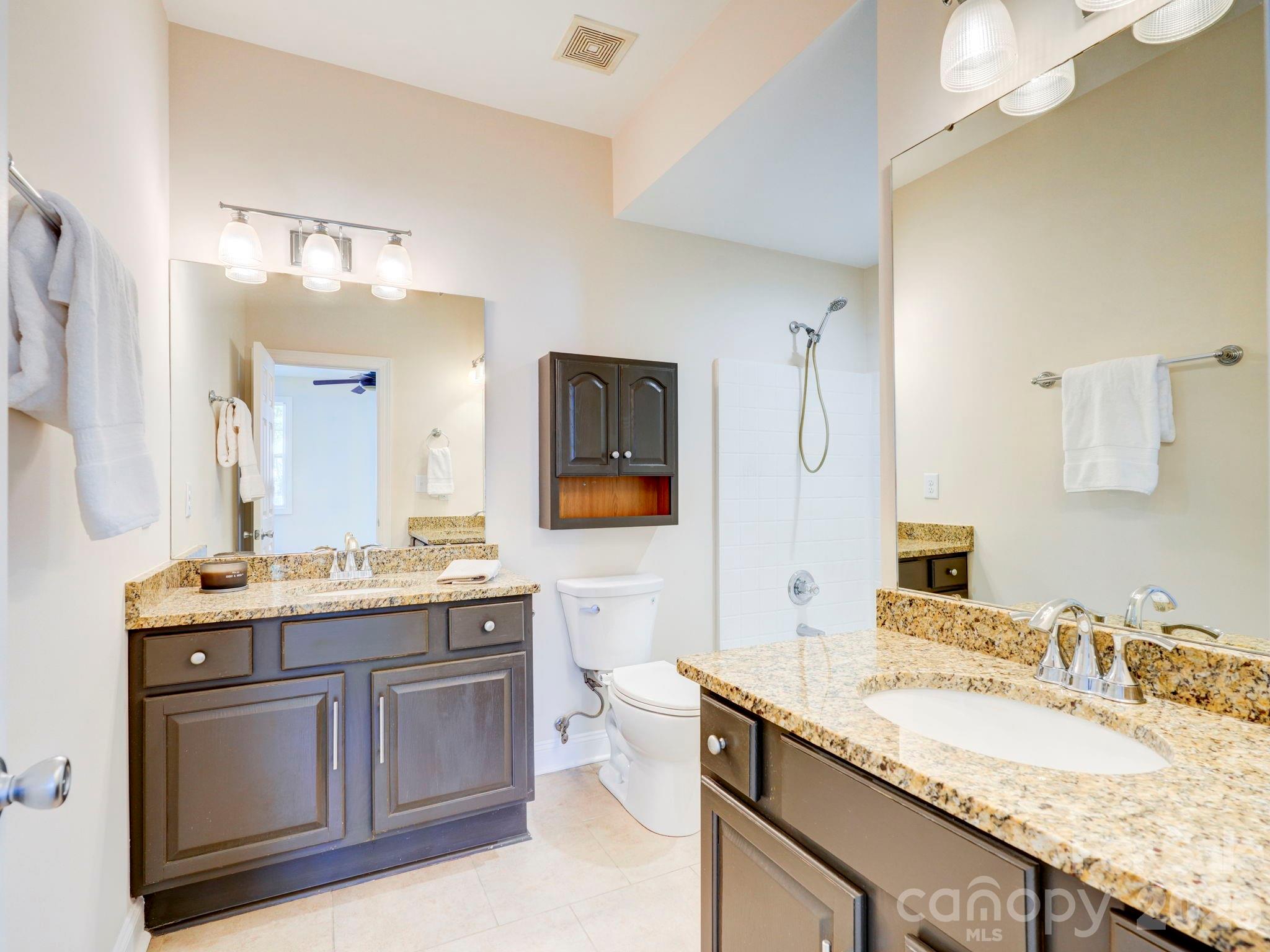 2025 Gable Way Lane Matthews, NC 28104 - Photo 28 of 36 a bathroom with a granite countertop double vanity sink and mirror