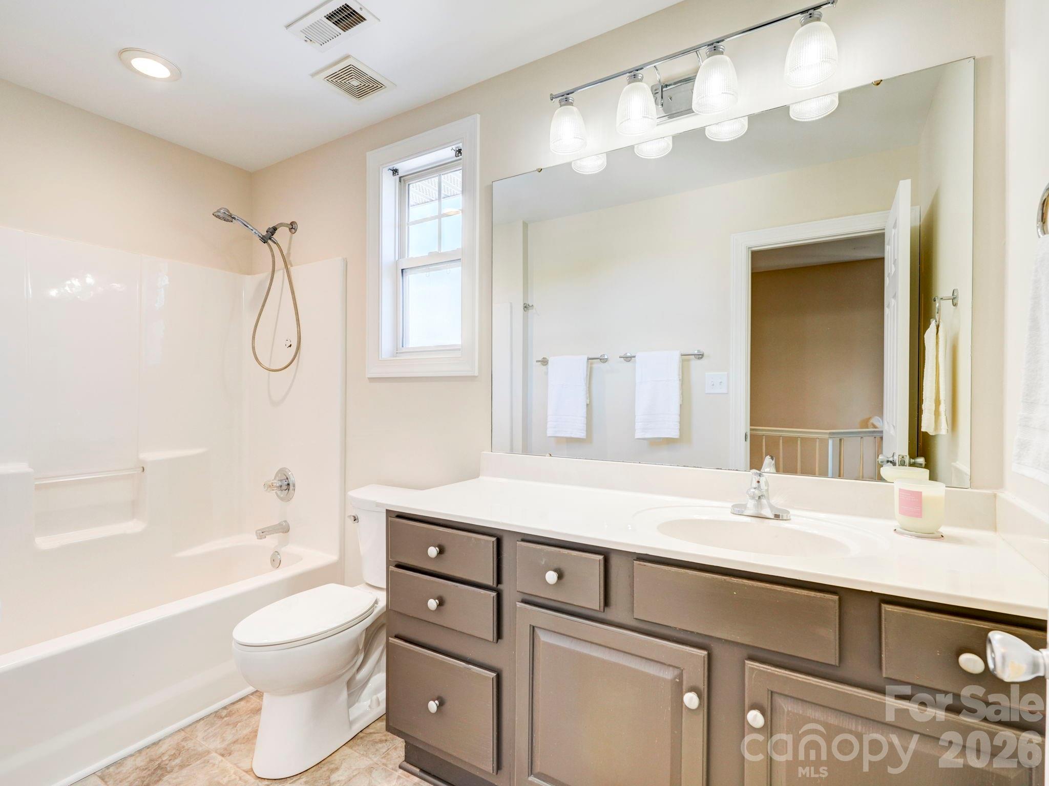 2025 Gable Way Lane Matthews, NC 28104 - Photo 31 of 36 a bathroom with a granite countertop sink a toilet and shower