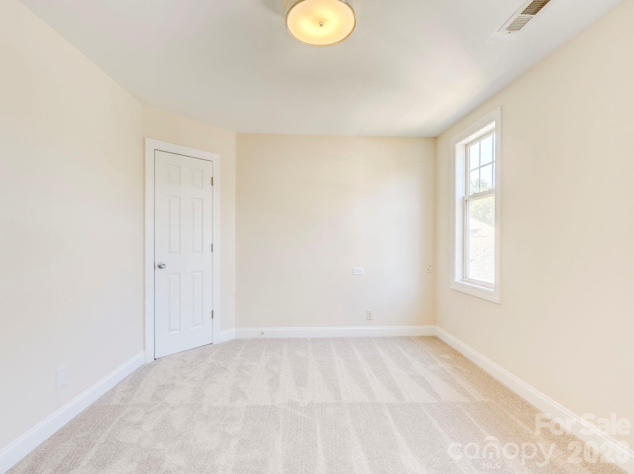2025 Gable Way Lane Matthews, NC 28104 - Photo 33 of 36 a view of an empty room with window and wooden floor