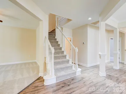 a view of entryway and hall with wooden floor