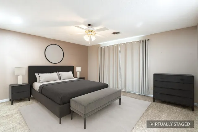 an empty room with windows and fan