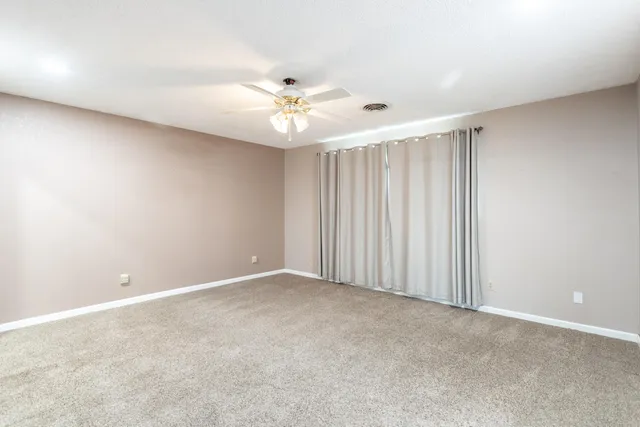 a bathroom with a granite countertop sink toilet a mirror and shower