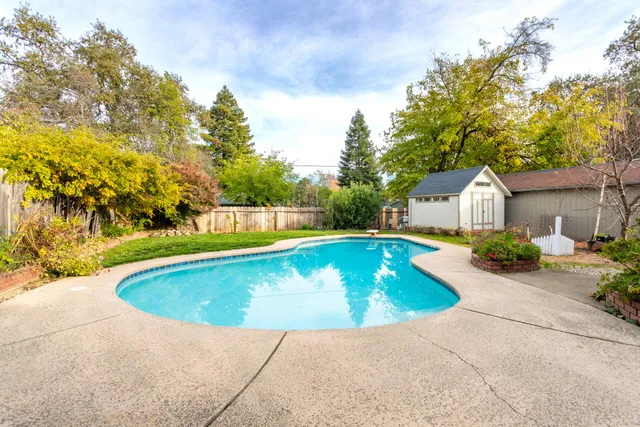 a view of swimming pool with wooden fence