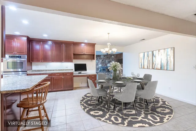 a kitchen with stainless steel appliances kitchen island granite countertop a sink and cabinets