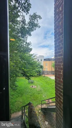 a view of a backyard with table and chairs and potted plants