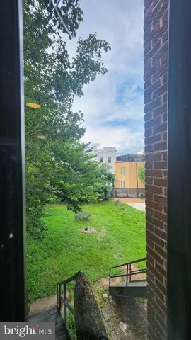 a view of a backyard with table and chairs and potted plants