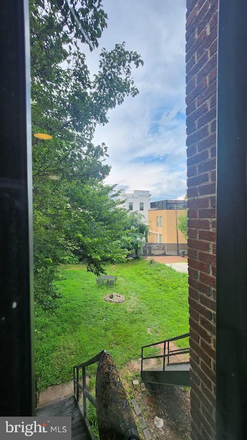1422 W Street Southeast, Unit 2 Washington, DC 20020 - Photo 5 of 12 a view of a backyard with table and chairs and potted plants