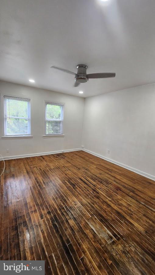 1422 W Street Southeast, Unit 2 Washington, DC 20020 - Photo 7 of 12 an empty room with wooden floor chandelier fan and windows
