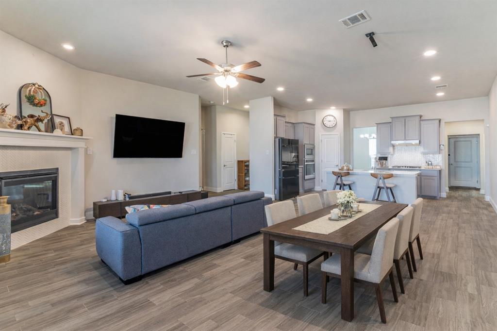 10638 Cherry Tree Way Grand Prairie, TX 76065 - Photo 2 of 39 Spacious living room with electric fireplace; staged dining area.