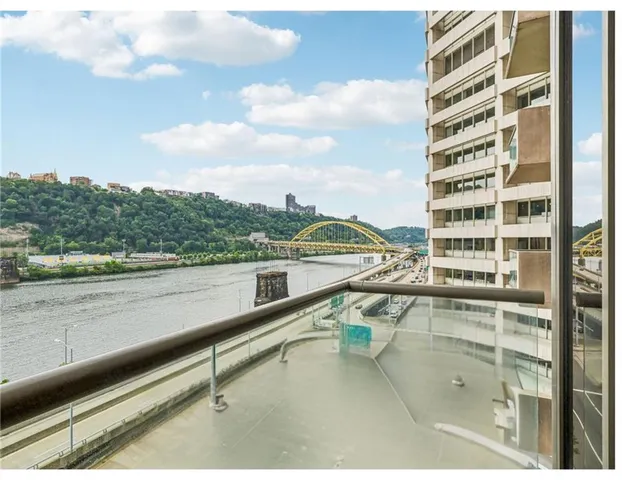 a living room with lots of furniture and view of kitchen