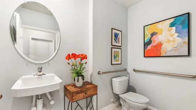 a bathroom with a toilet a sink and a mirror