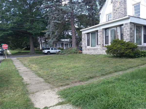 a couple of table and chairs in front of house