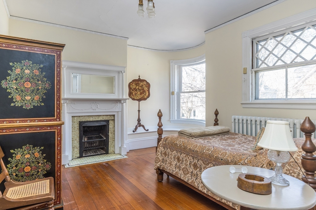 37 Osborne Road Brookline, MA 02446 - Photo 12 of 16 a bedroom with a bed and a fireplace