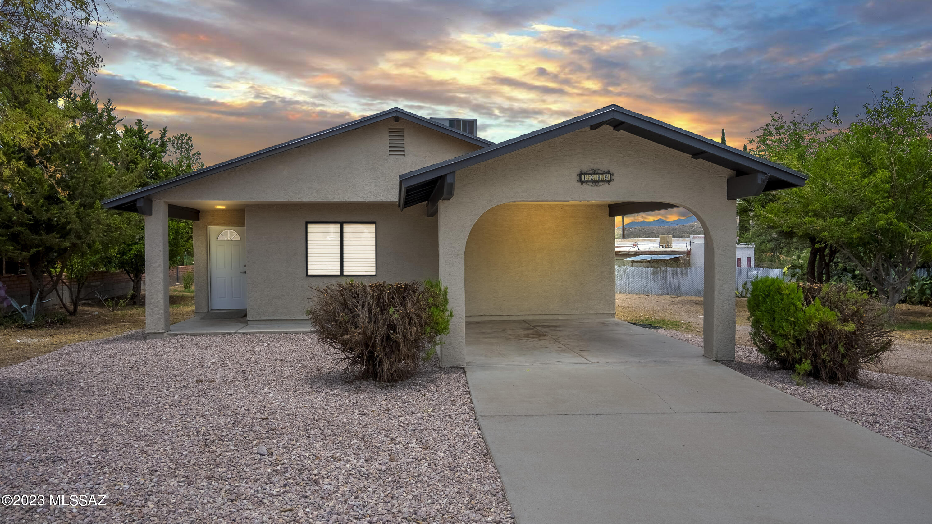 1299 Imuris Court Rio Rico, AZ 85648 - Photo 1 of 18 a front view of a house with a yard