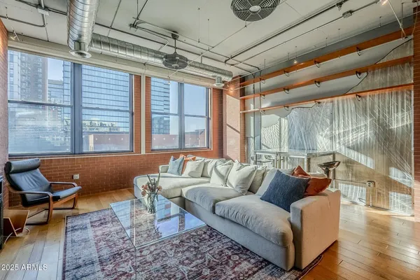a living room with furniture and a large window