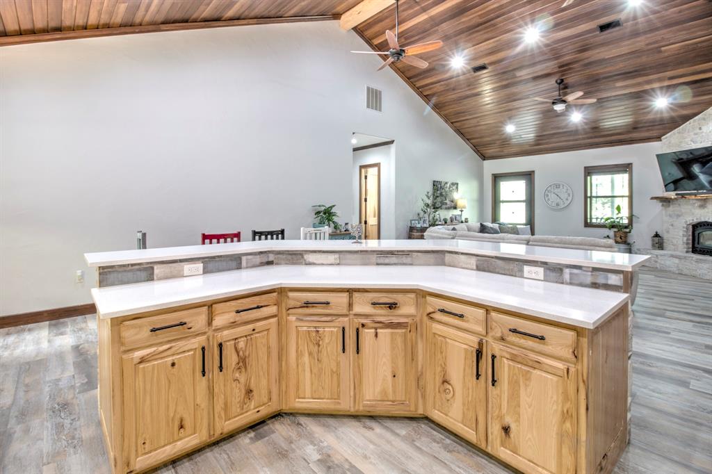 1024 Jordan Creek Road Collinsville, TX 76233 - Photo 11 of 40 This expansive island bar offers a massive workspace and serves as a natural gathering hub within the home's open-concept layout.