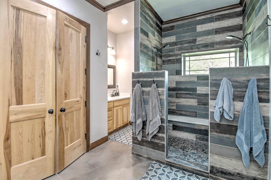 1024 Jordan Creek Road Collinsville, TX 76233 - Photo 14 of 40 It’s a master suite designed for ultimate relaxation and high-end functionality.