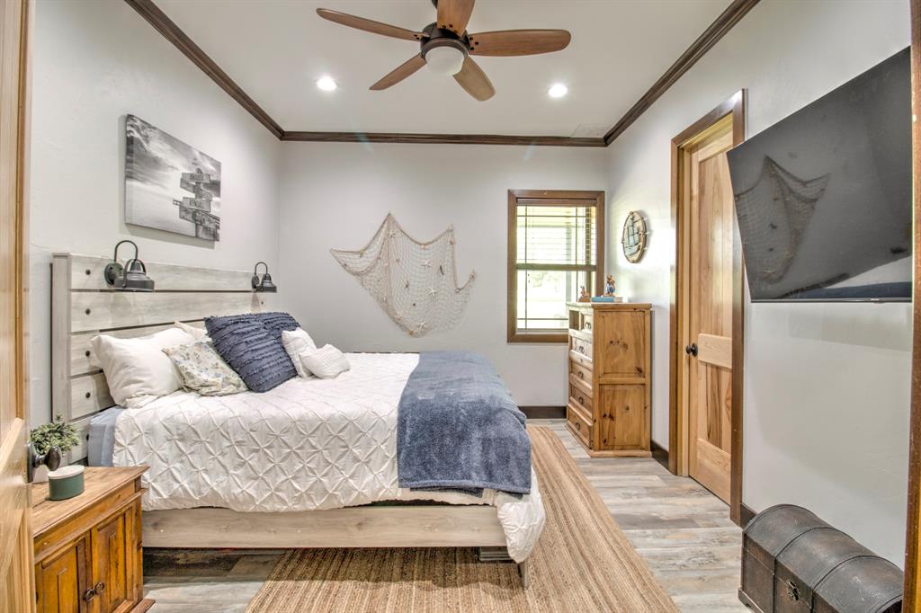 1024 Jordan Creek Road Collinsville, TX 76233 - Photo 16 of 40 This charming oversized second bedroom offers a tranquil retreat for guests or family members, perfectly continuing the home's "modern rustic" theme, with large walk in closet.
