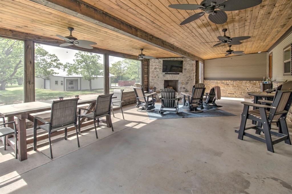 1024 Jordan Creek Road Collinsville, TX 76233 - Photo 22 of 40 Whether you're hosting a backyard BBQ or looking for a peaceful place to lounge, this porch brings the best of the indoors to the fresh air.