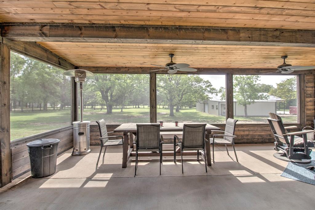 1024 Jordan Creek Road Collinsville, TX 76233 - Photo 23 of 40 Soak in the pristine views, of the sprawling lawn and mature hardwood in total comfort.