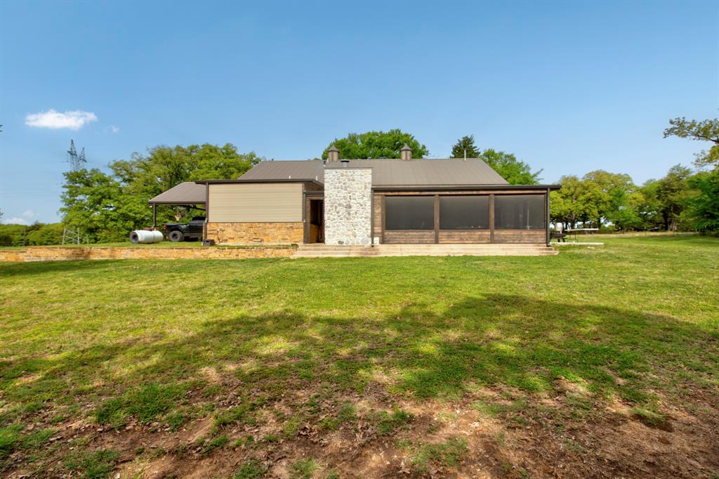 1024 Jordan Creek Road Collinsville, TX 76233 - Photo 27 of 40 This rear view of the property showcases the view of this outdoor living design!