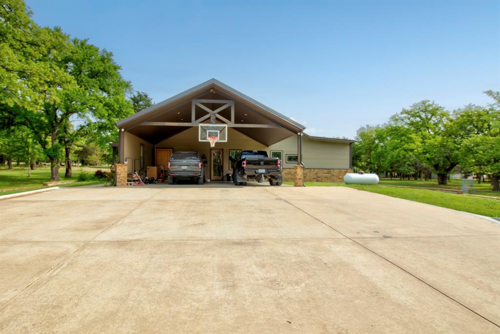 1024 Jordan Creek Road Collinsville, TX 76233 - Photo 3 of 40 Attached Large Carport, with plenty of room for large vehicles and outdoor toys!