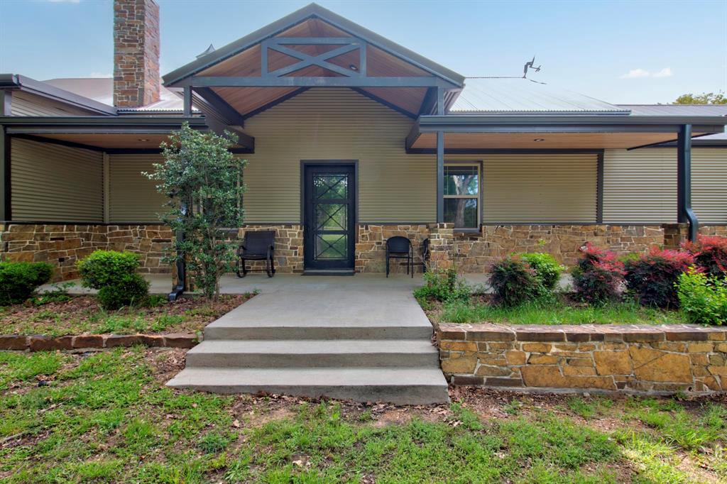 1024 Jordan Creek Road Collinsville, TX 76233 - Photo 4 of 40 This beautifully covered front entrance invites you to slow down and take in the surrounding scenery.
